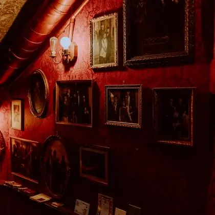 The wall of portraits on the staircase