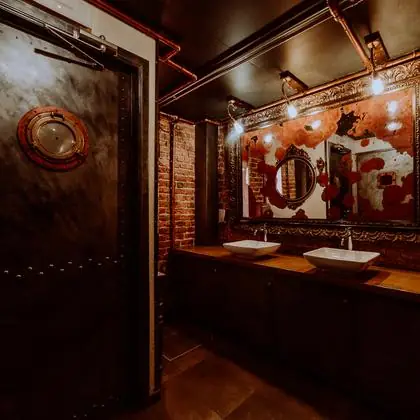 Even the washrooms: a submarine door and bare brick